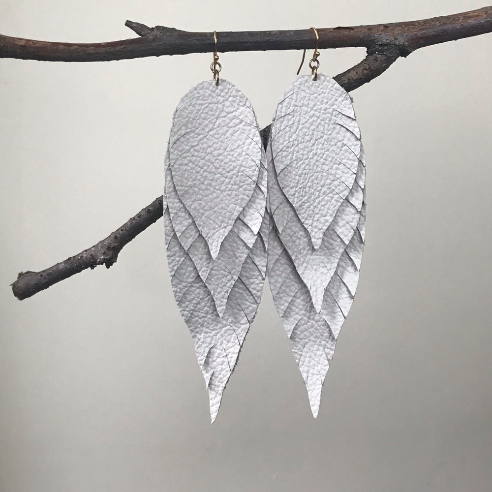 Off white/cream three leaf leather earrings.